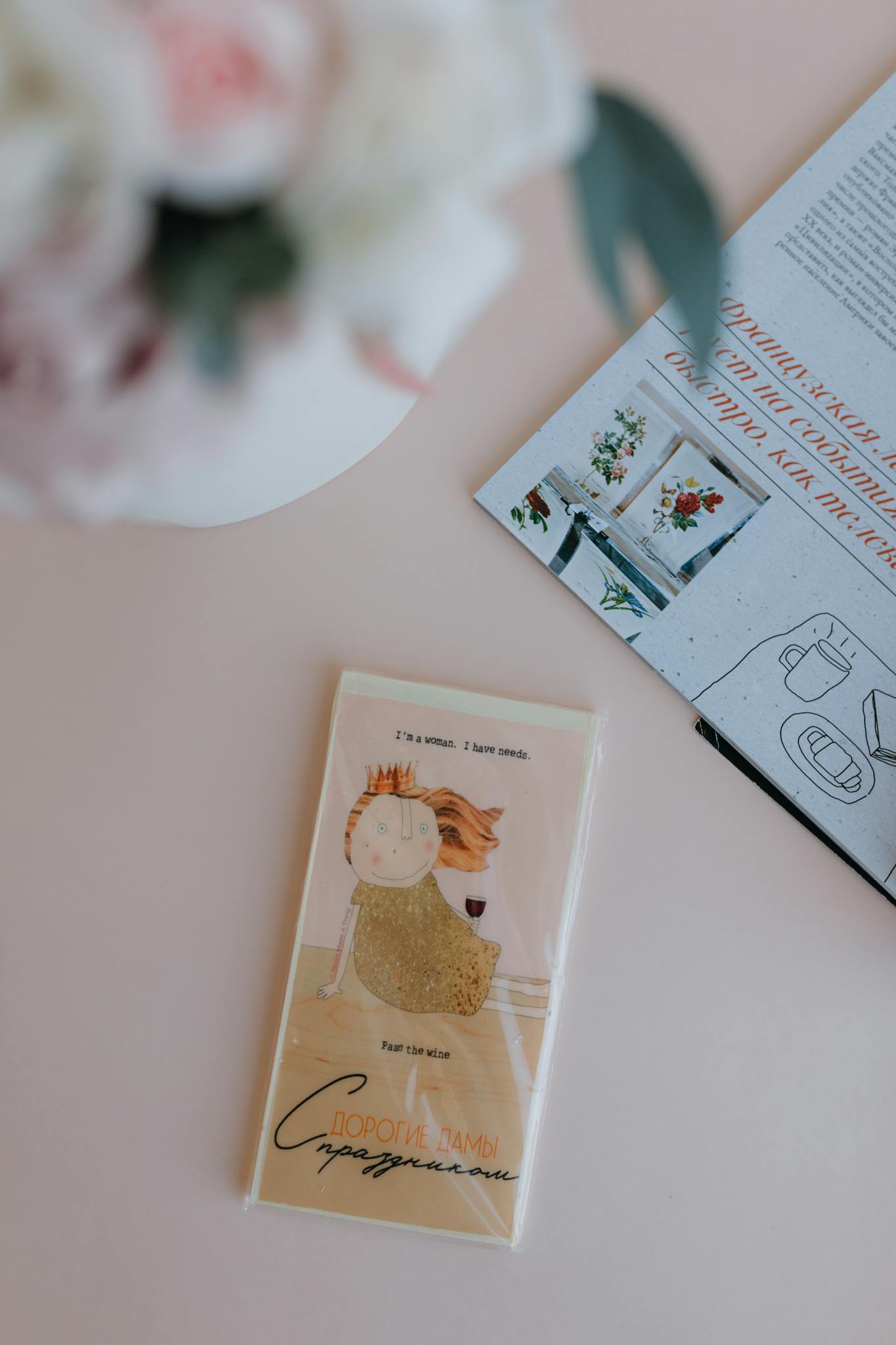 Artistic greeting card with floral decoration on a pastel surface, perfect for special occasions.