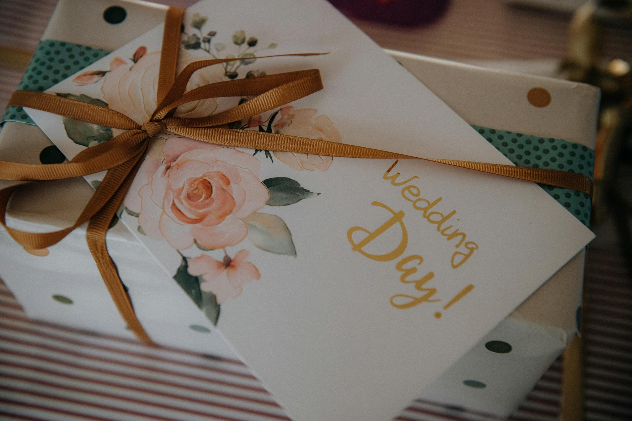 Beautifully wrapped wedding present with floral card and ribbon, perfect for celebrating a special day.